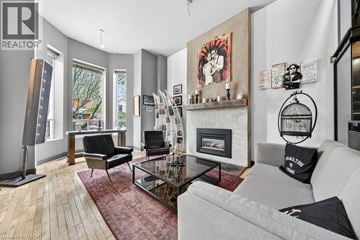 Hamilton apartment for rent - A living room with a grey couch and a fireplace.