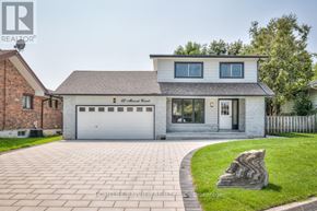 Whitby (Lynde Creek) apartment for rent - A house with a grey garage door and a stone sculpture in the front yard.
