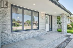 Whitby (Lynde Creek) apartment for rent - A house with a stone wall and a glass door.