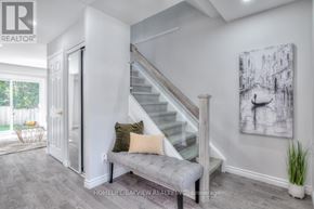 Whitby (Lynde Creek) apartment for rent - A living room with a staircase and a painting on the wall.