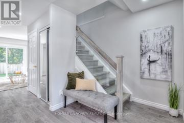 Whitby (Lynde Creek) apartment for rent - A living room with a staircase and a painting on the wall.