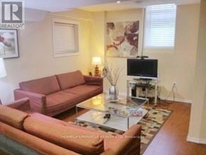 Whitby (Blue Grass Meadows) apartment for rent - A living room with a red couch and a glass coffee table.