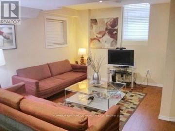 Whitby (Blue Grass Meadows) apartment for rent - A living room with a red couch and a glass coffee table.