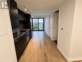 Hamilton (Beasley) condo for rent - A kitchen with black cabinets and a wooden floor.