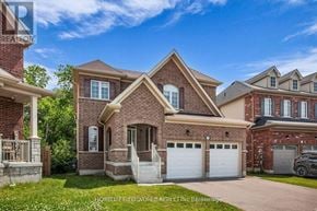 Clarington (Bowmanville) apartment for rent - A large brick house with a white garage door is for sale.