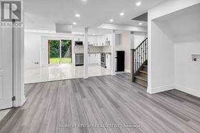 Clarington (Bowmanville) apartment for rent - A spacious living room with a staircase leading to the upper floor.