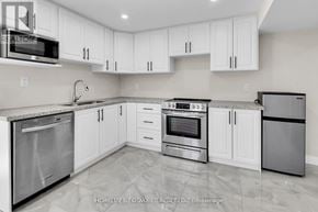 Clarington (Bowmanville) apartment for rent - A kitchen with white cabinets and stainless steel appliances.