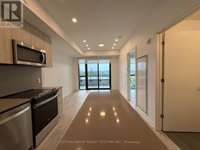 Milton (Cb Cobban) condo for rent - A modern kitchen with a microwave above the stove and a view of the outdoors through the glass doors.