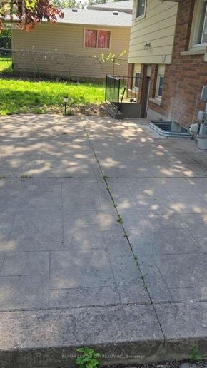 London North (North K) apartment for rent - A concrete patio with a small tree growing in the middle.