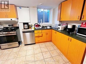 London North (North K) apartment for rent - A kitchen with wooden cabinets and a tile floor.