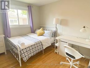 London North (North K) apartment for rent - A brown table with four white chairs in front of a white wall.