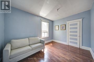Toronto (Dovercourt-Wallace Emerson-Junction) apartment for rent - A living room with a couch and a door.