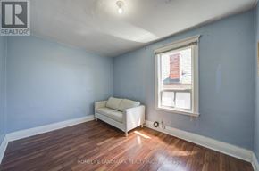 Toronto (Dovercourt-Wallace Emerson-Junction) apartment for rent - A room with a white couch and a window with blinds.