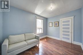 Toronto (Dovercourt-Wallace Emerson-Junction) apartment for rent - A living room with a couch and a door.