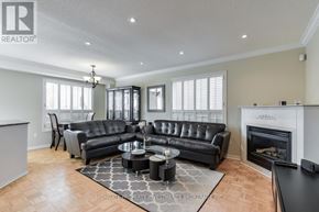 Vaughan (Maple) apartment for rent - A living room with a black leather couch and a fireplace.