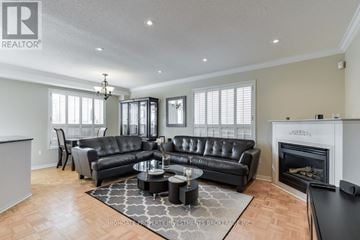 Vaughan (Maple) apartment for rent - A living room with a black leather couch and a fireplace.