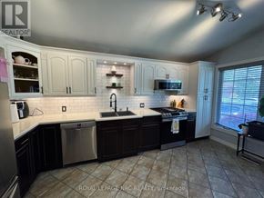 St. Catharines (Burleigh Hill) apartment for rent - A kitchen with white cabinets and a tiled floor.