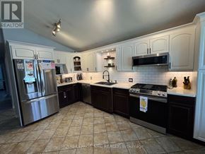 St. Catharines (Burleigh Hill) apartment for rent - A kitchen with a tile floor and a stainless steel refrigerator.