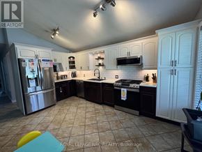 St. Catharines (Burleigh Hill) apartment for rent - A kitchen with white cabinets and a tile floor.