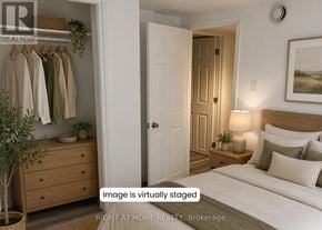Oshawa (Central) apartment for rent - A virtual staged bedroom with a bed, nightstand, and a plant.