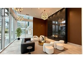 Burnaby apartment for rent - A modern waiting area with black and white furniture and a chandelier.