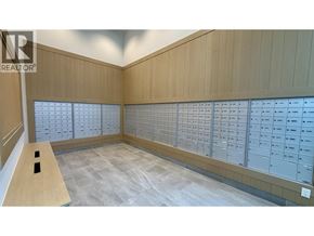 Burnaby apartment for rent - A room with a long table and a wall of mailboxes.