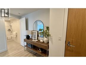 Burnaby apartment for rent - A bathroom with a wooden door and a mirror above a shelf with a plant and other decorations.