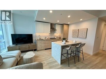 Burnaby apartment for rent - A modern kitchen with a dining table set for two.