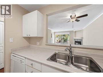 Vancouver apartment for rent - A modern kitchen with a sink, dishwasher and a fan.