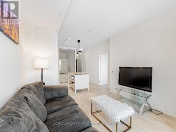 Toronto (Newtonbrook East) condo for rent - A modern living room with a grey sofa and a glass coffee table.