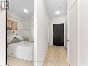 Toronto (Newtonbrook East) condo for rent - A bedroom with a bed, a dresser, and a black door.