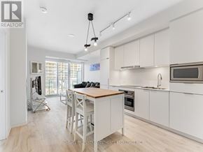 Toronto (Newtonbrook East) condo for rent - A modern kitchen with white cabinets and a wooden island.