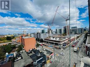 Toronto (South Parkdale) condo for rent - A construction site with a crane and buildings in the background.