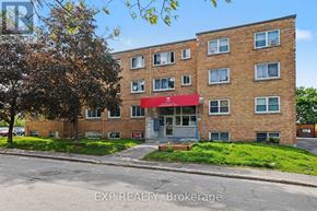 Ottawa multi-family for rent - A brick building with a red awning is for sale.