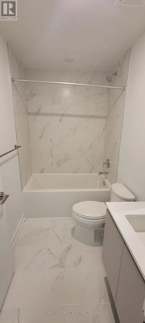 Oakville (Go Glenorchy) condo for rent - A white bathroom with marble flooring and a bathtub.