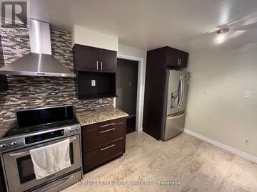 London North (North F) apartment for rent - A kitchen with a stove top oven and a refrigerator.