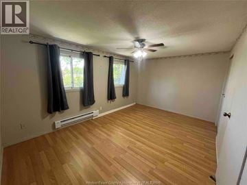 Windsor townhouse for rent - A room with a ceiling fan and wooden flooring.