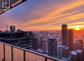 Toronto (Church-Yonge Corridor) condo for rent - A cityscape at sunset with a sunset in the background.
