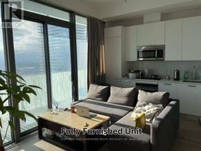 Toronto (Church-Yonge Corridor) condo for rent - A fully furnished living room with a couch, coffee table, and a view of the city.