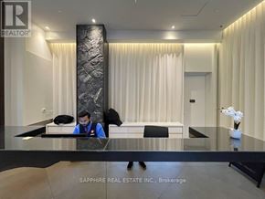Toronto (Waterfront Communities) condo for rent - A real estate office with a reception desk and a person behind it.