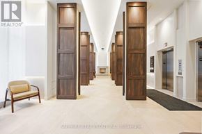 Toronto (Waterfront Communities) condo for rent - A hallway with wooden doors and a chair on the left side.