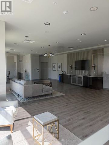 Waterloo house for rent - A modern living room with a grey sofa and a wooden floor.