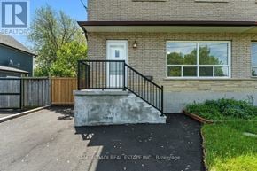 Oshawa (Lakeview) apartment for rent - A house with a white door and a black railing.