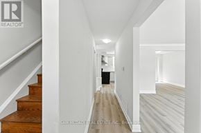 Oshawa (Lakeview) apartment for rent - A hallway with a staircase on the left and a door on the right.