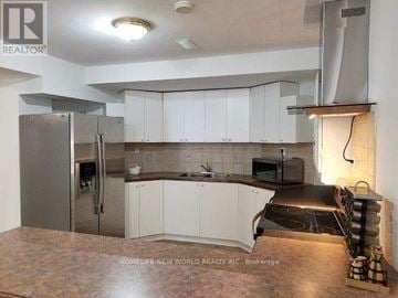 Richmond Hill (North Richvale) apartment for rent - A kitchen with white cabinets and a refrigerator.