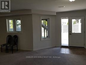 Richmond Hill (North Richvale) apartment for rent - A room with a white door, two windows, and a chair.