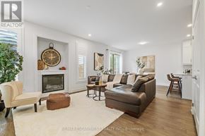 Burlington (Headon) townhouse for rent - A living room with a fireplace and a couch.