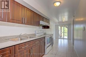 Markham (Cedarwood) apartment for rent - A kitchen with wooden cabinets and a white oven.
