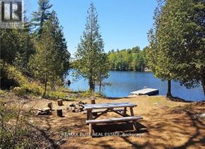Frontenac (Frontenac Centre) apartment for rent - A picnic table sits in front of a lake surrounded by trees.
