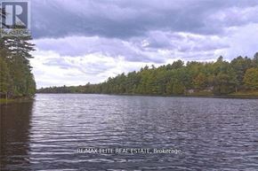 Frontenac (Frontenac Centre) apartment for rent - A lake surrounded by trees under a cloudy sky.